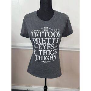 Tattoos, Pretty Eyes, and Thick Thighs Short Sleeve Graphic Tee Size Medium